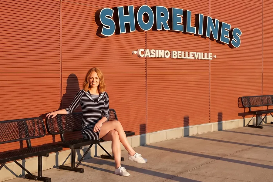 Woman on the bench under the Shorelines sign