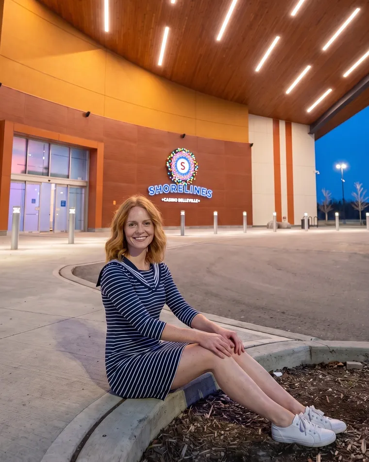 Woman on the curb at the Shorelines Belleville entrance